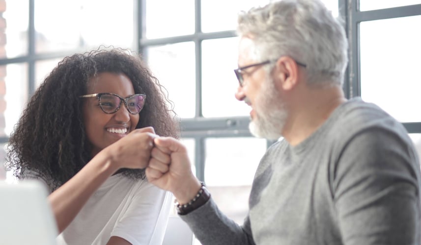 Woman and man sharing a fist bump