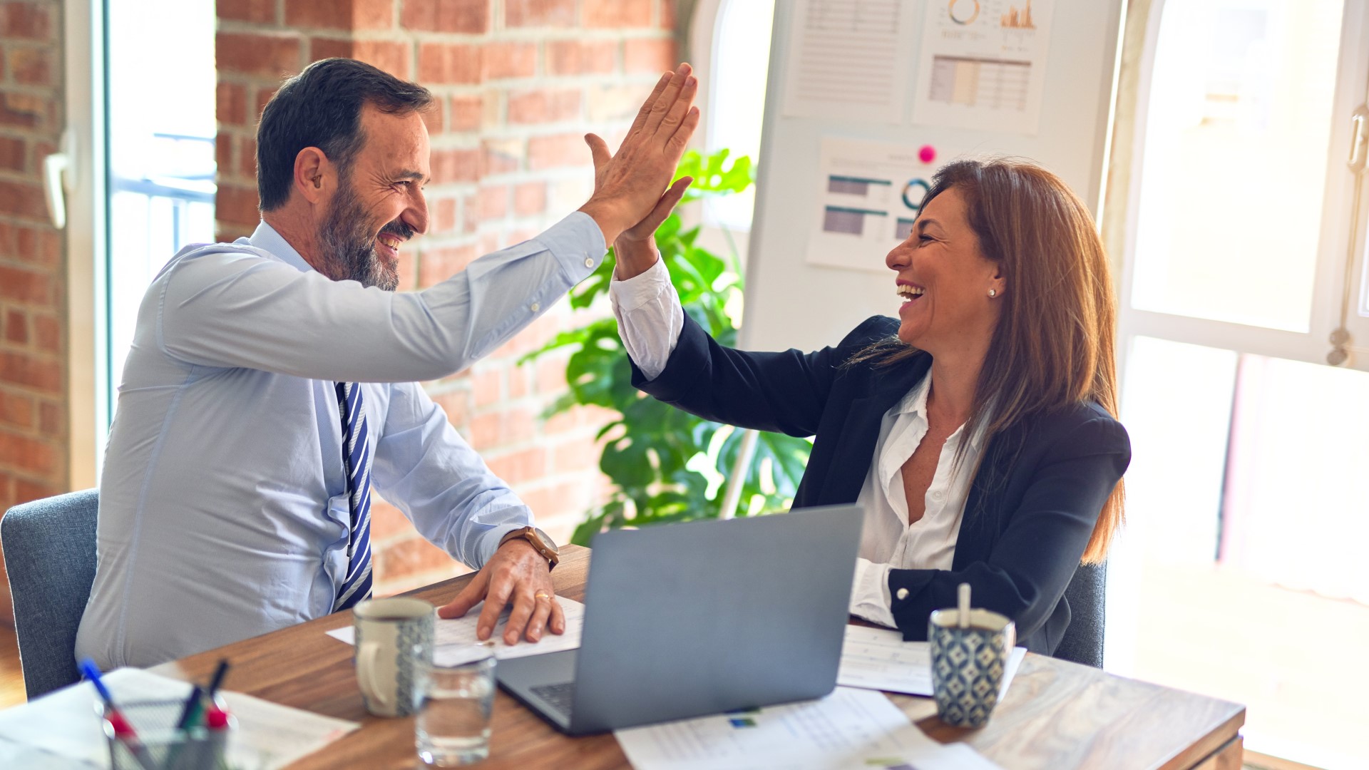Man and Woman High Fiving About Awesome Websites