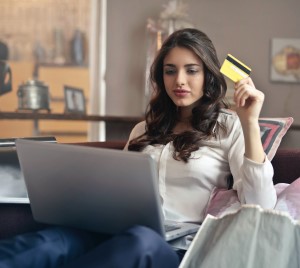 Woman Holding Credit Card Shopping on Laptop