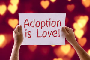 Adoption is Love card with heart bokeh background