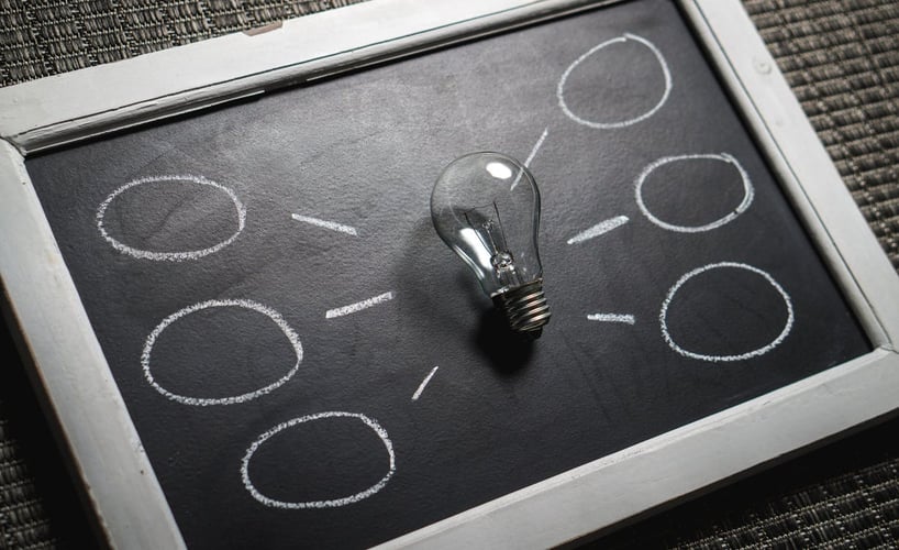 A light bulb on a chalk board representing Marketing Ideas to Engage Your Customers