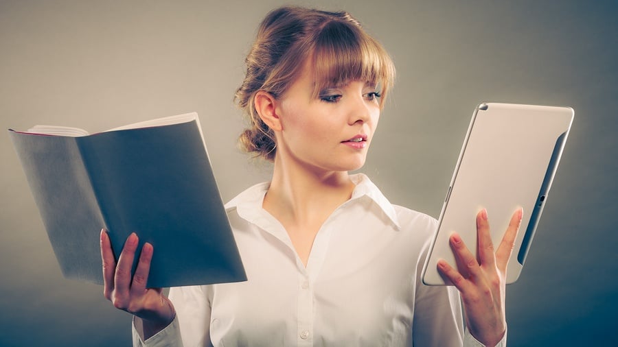 Woman learning by reading eBooks and guides about banks and credit unions.